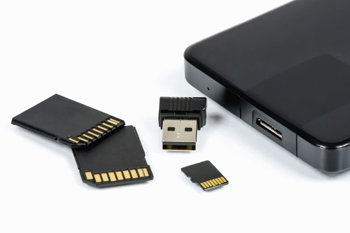 A number of portable storage cards and USB accessories on a white background.